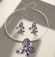 Silver choker and earring set featuring purple butterfly pendants with rhinestone accents displayed on a black bust stand.
