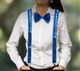 Blue sequin suspenders with Y-back design and silver clips displayed on a light wooden surface.