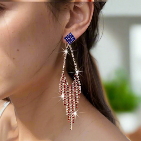 Long red, white, and blue rhinestone fringe earrings with a blue star-studded stud top and cascading sparkly fringe design.