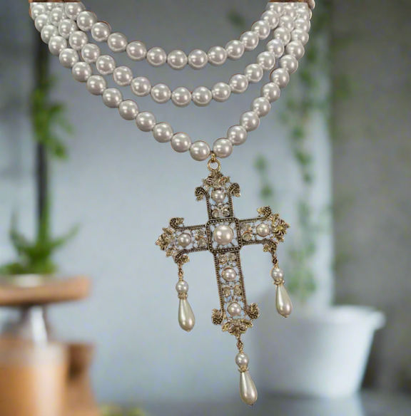 Multi-strand pearl choker necklace with ornate gold filigree cross pendant featuring faux pearls and teardrop pearl drops, elegant and vintage style.