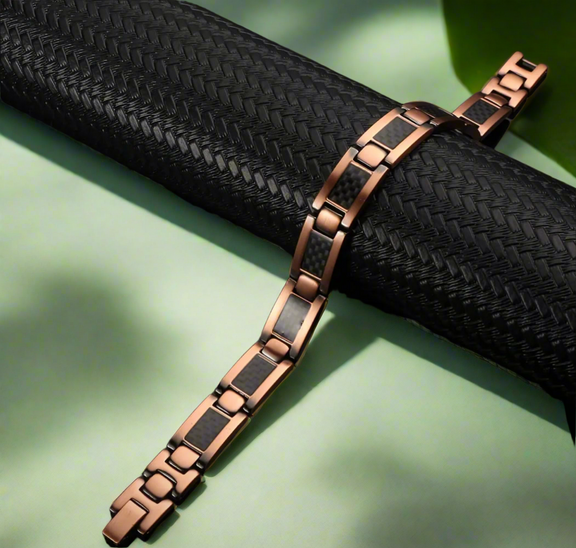 Men’s rose gold stainless steel link bracelet with black carbon fiber inlays and fold-over clasp, displayed on white background.