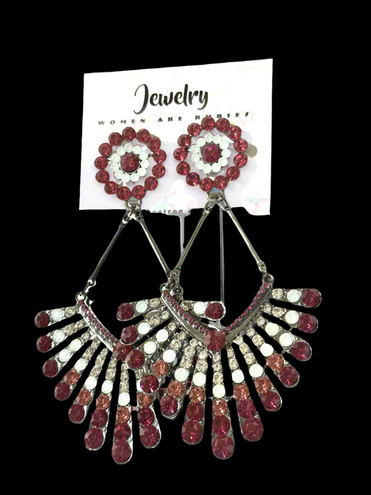 The Glory in Bloom Fan Earrings by Desiree W.A.R Store are striking statement pieces adorned with red and white gemstones, elegantly displayed on a jewelry card against a captivating black backdrop.