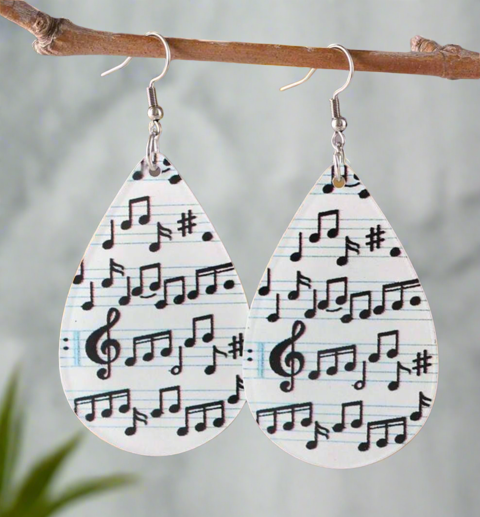Teardrop-shaped earrings with black musical notes printed on a white background, featuring silver hooks, perfect for music lovers and musicians.