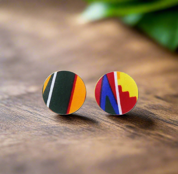 Ankara fabric-wrapped triple-strand necklace in bold red, yellow, green, and blue with matching round African print button earrings displayed on a black bust stand.
