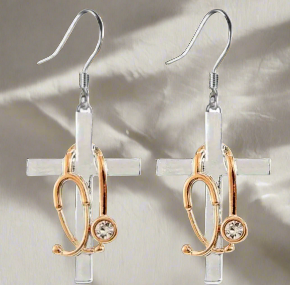 Silver cross earrings with gold-tone stethoscope charms and rhinestone accents, symbolizing faith and the medical profession.