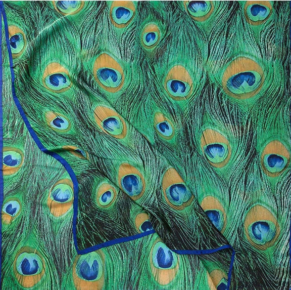 Luxurious green peacock feather scarf with royal blue trim, made from silky, lightweight fabric, perfect as a headwrap, shawl, or statement accessory for elegant styling