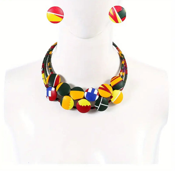 African-inspired Ankara print necklace with multicolor fabric-wrapped beads and matching button earrings displayed on a mannequin.