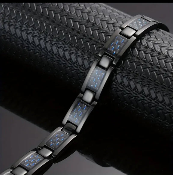 Black stainless steel link bracelet with blue carbon fiber inlays and magnetic accents, displayed on white background.