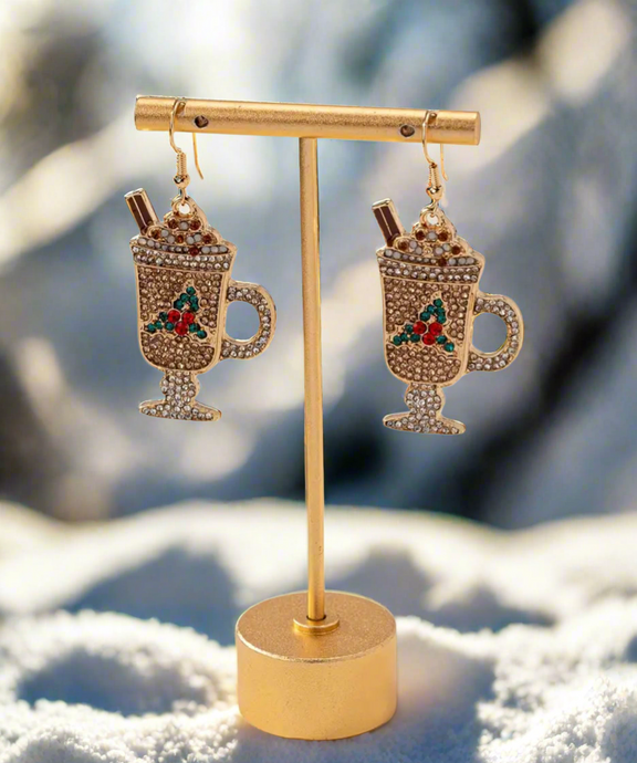 Holiday Cocoa Sparkle Earrings shaped like festive hot chocolate mugs with whipped cream, cinnamon sticks, and colorful crystal accents in gold, red, and green.