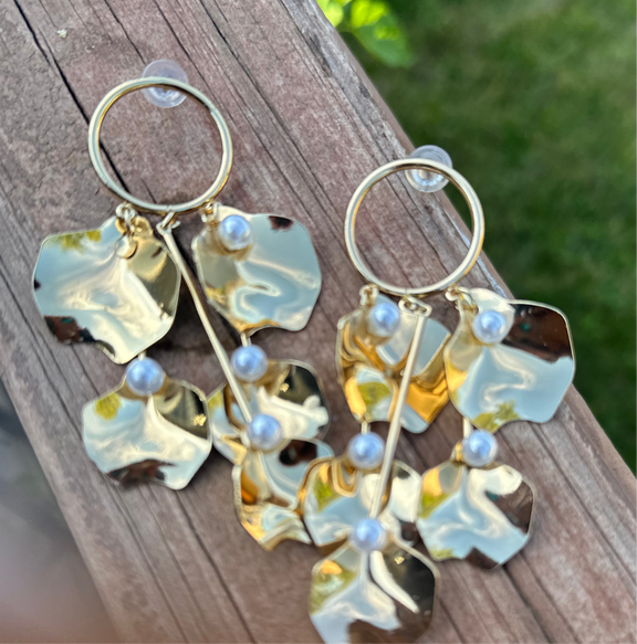 Golden Petal Cascade Earrings featuring dangling gold petal-shaped charms with faux pearls, statement jewelry for women