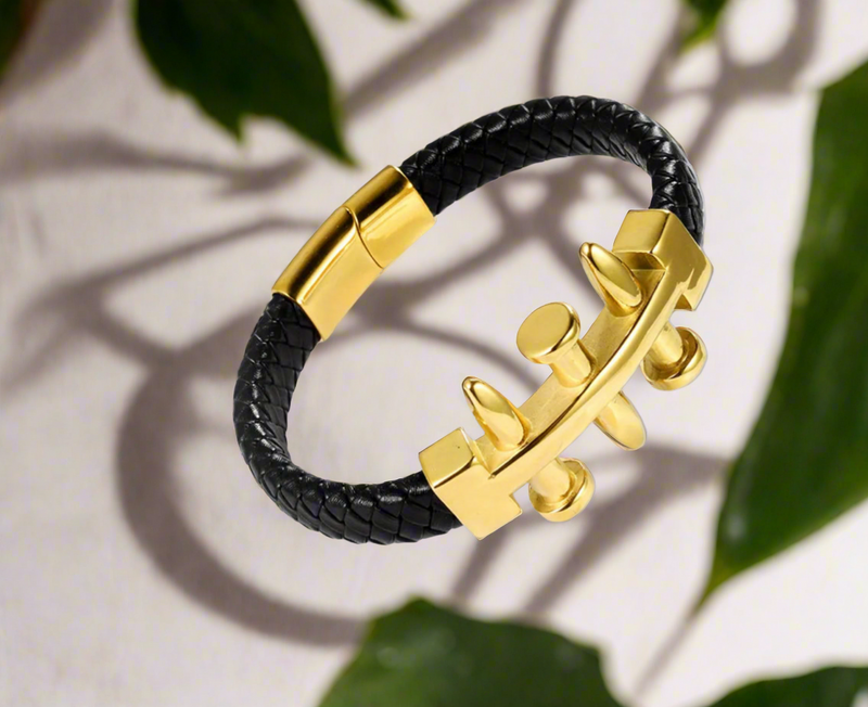 Men’s faux leather braided bracelet with gold-tone bolt centerpiece and magnetic clasp displayed on white background.