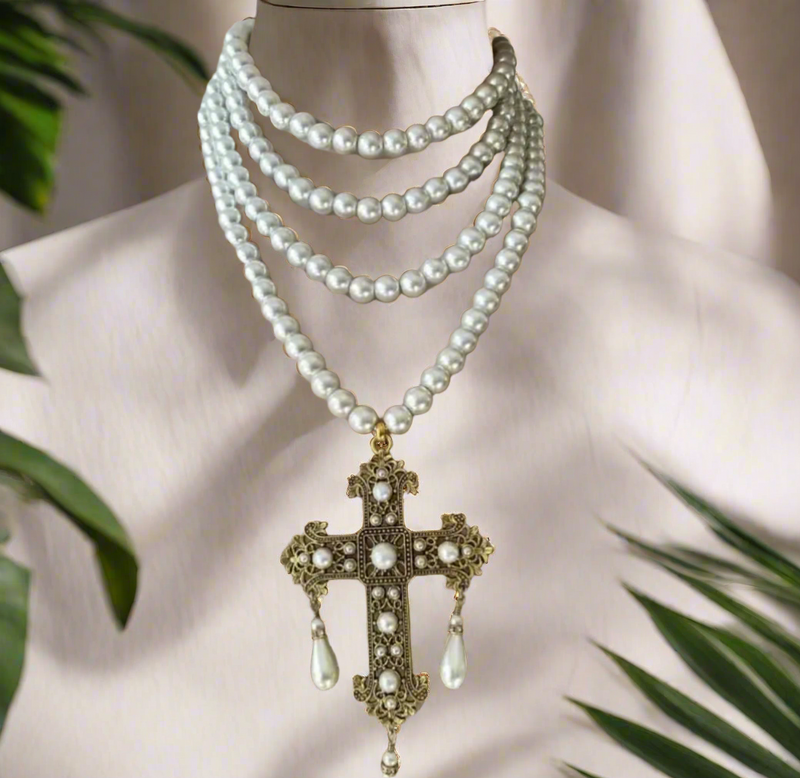 Multi-strand pearl choker necklace with ornate gold filigree cross pendant featuring faux pearls and teardrop pearl drops, elegant and vintage style.
