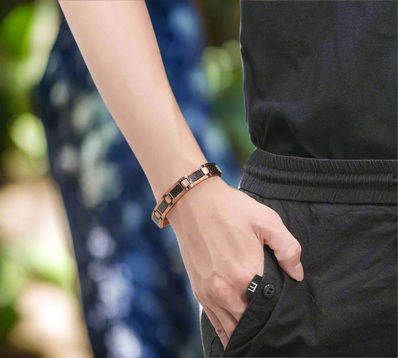 Men’s rose gold stainless steel link bracelet with black carbon fiber inlays and fold-over clasp, displayed on white background.