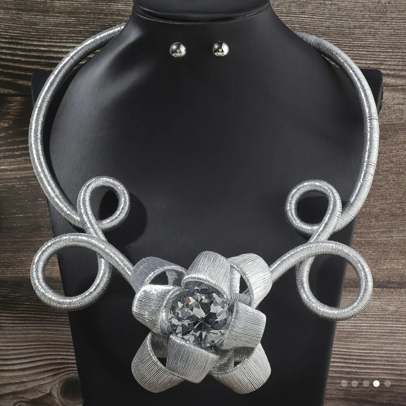 Elegant silver statement choker necklace featuring handcrafted wire loops and a dazzling crystal flower centerpiece, perfect for special occasions and bold fashion lovers