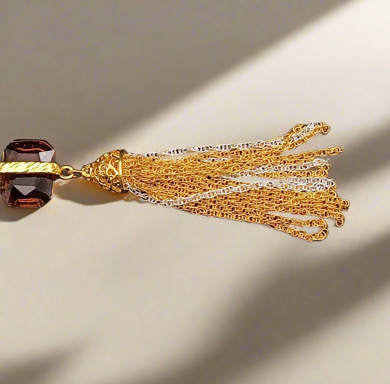 Adira Royal Tassel Earrings featuring a textured gold stud, brown gemstone, and elegant cascading gold and silver tassels – a bold and luxurious statement piece.