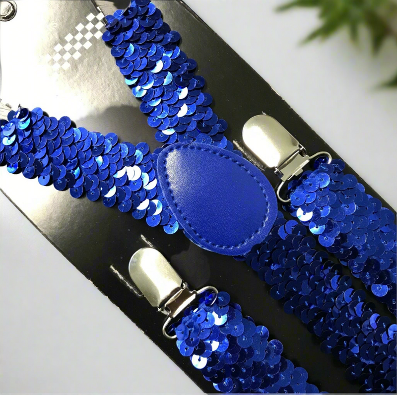 Blue sequin suspenders with Y-back design and silver clips displayed on a light wooden surface.