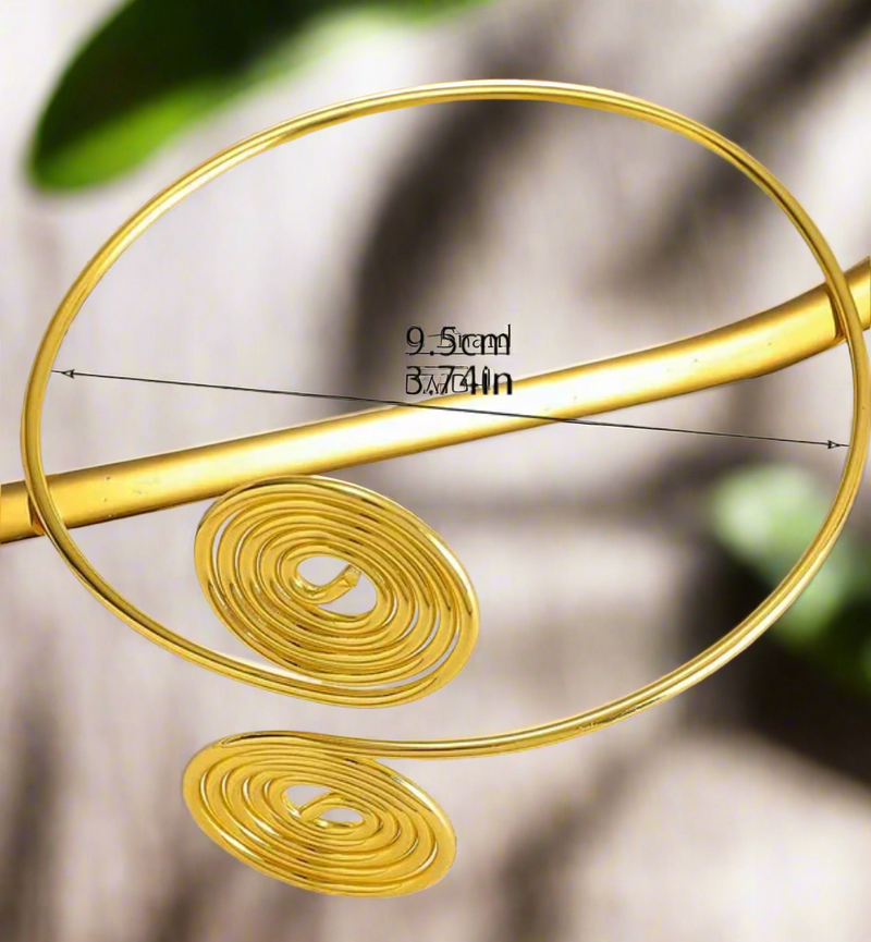 Gold-tone double spiral arm cuff, adjustable upper arm bracelet with twin swirl design, bold minimalist boho chic jewelry.
