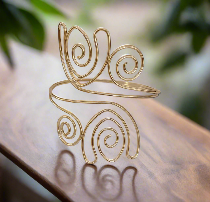 Gold-tone spiral swirl upper arm cuff for women, adjustable open bangle, bold statement arm jewelry for boho or festival looks.