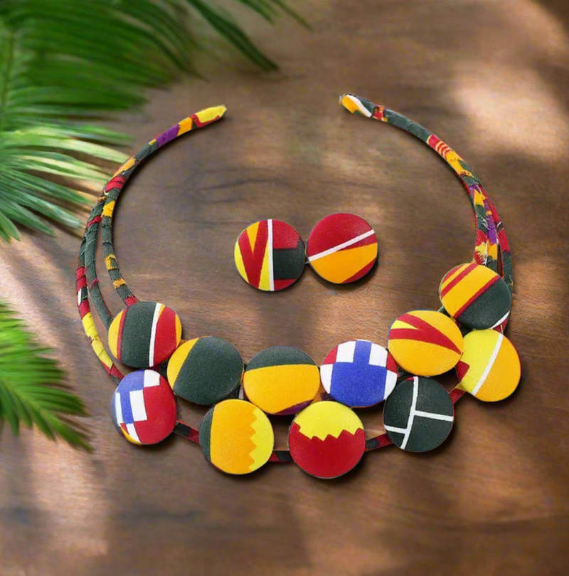 African-inspired Ankara print necklace with multicolor fabric-wrapped beads and matching button earrings displayed on a mannequin.