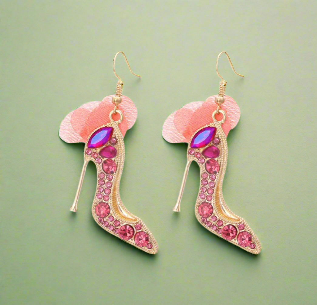 High heel-shaped pink rhinestone earrings with soft blush tulle detail and gold hooks.
