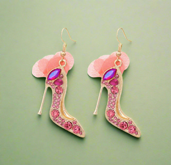 High heel-shaped pink rhinestone earrings with soft blush tulle detail and gold hooks.
