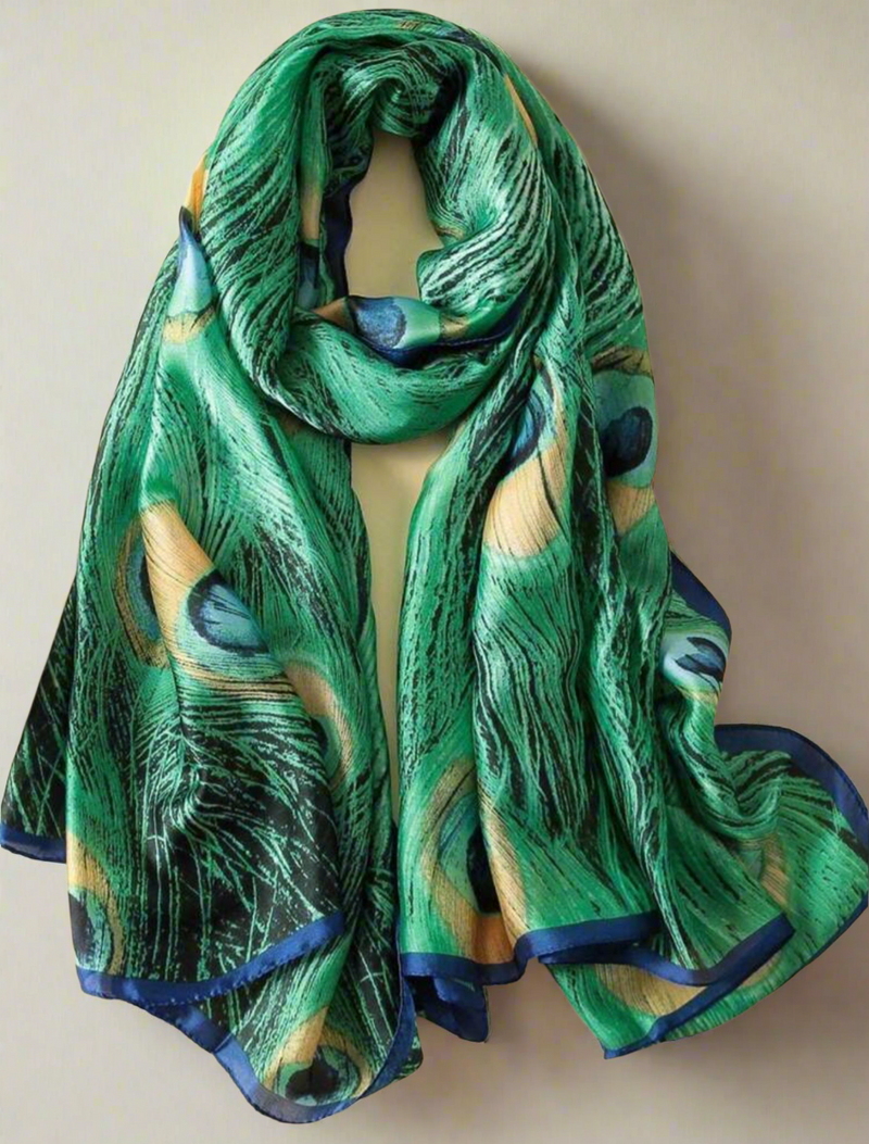 Luxurious green peacock feather scarf with royal blue trim, made from silky, lightweight fabric, perfect as a headwrap, shawl, or statement accessory for elegant styling
