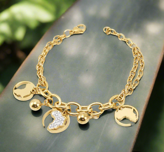 “Gold Africa charm bracelet with double link chain, gold map cutouts, rhinestone accents, and polished gold spheres, displayed on a white background.”
