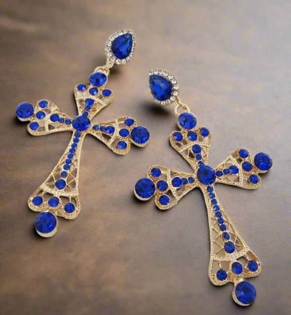 Royal Cross Statement Earrings featuring gold-tone filigree crosses adorned with sapphire-blue rhinestones and sparkling crystal accents, bold statement jewelry for women.