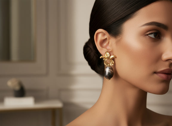 “Afia Orchid” statement earrings in radiant gold and floral design — inspired by the strength and beauty of the orchid flower. A perfect accessory that symbolizes grace, resilience, and feminine power.