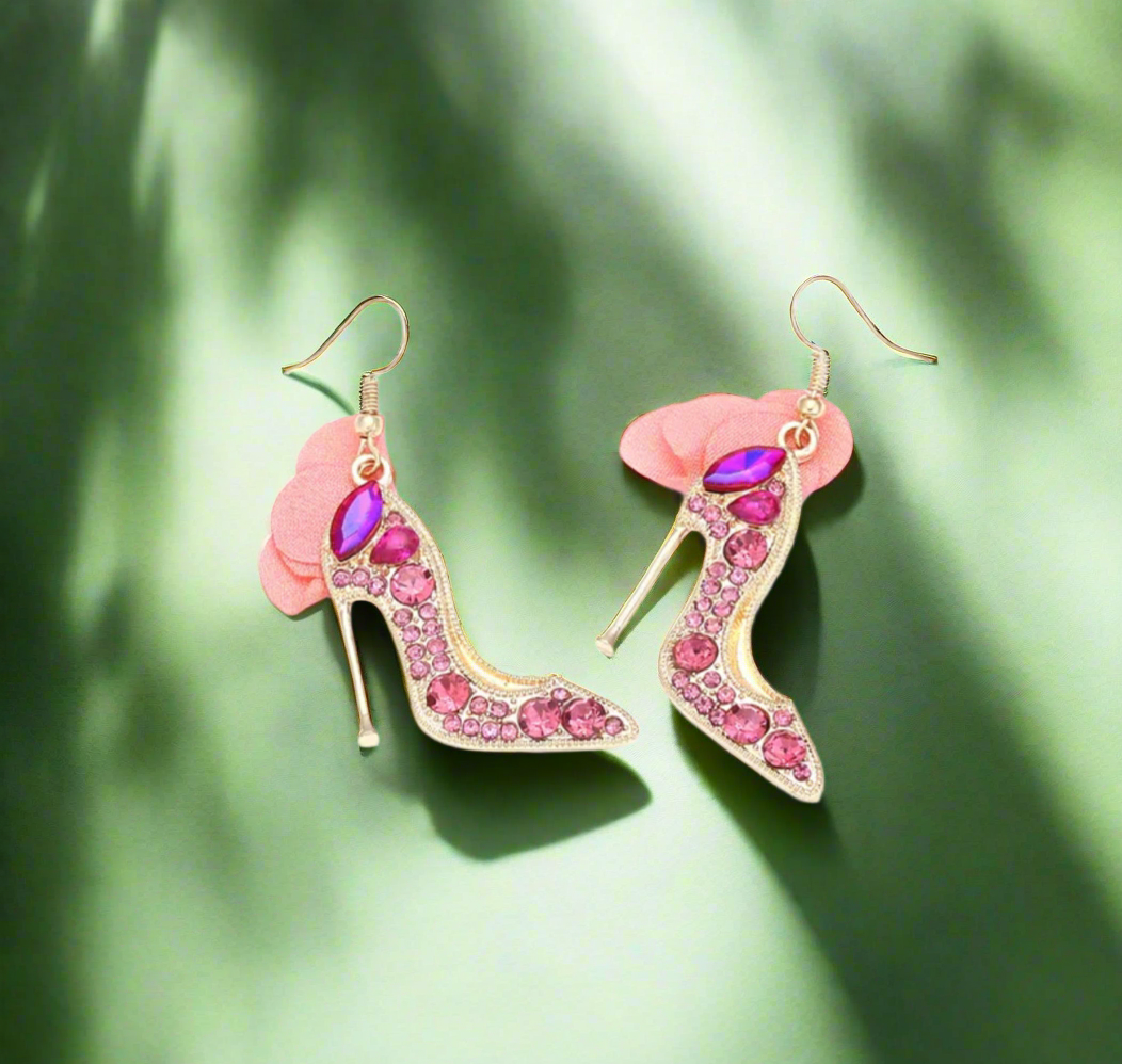 High heel-shaped pink rhinestone earrings with soft blush tulle detail and gold hooks.
