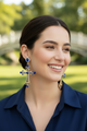 Royal Cross Statement Earrings featuring gold-tone filigree crosses adorned with sapphire-blue rhinestones and sparkling crystal accents, bold statement jewelry for women.
