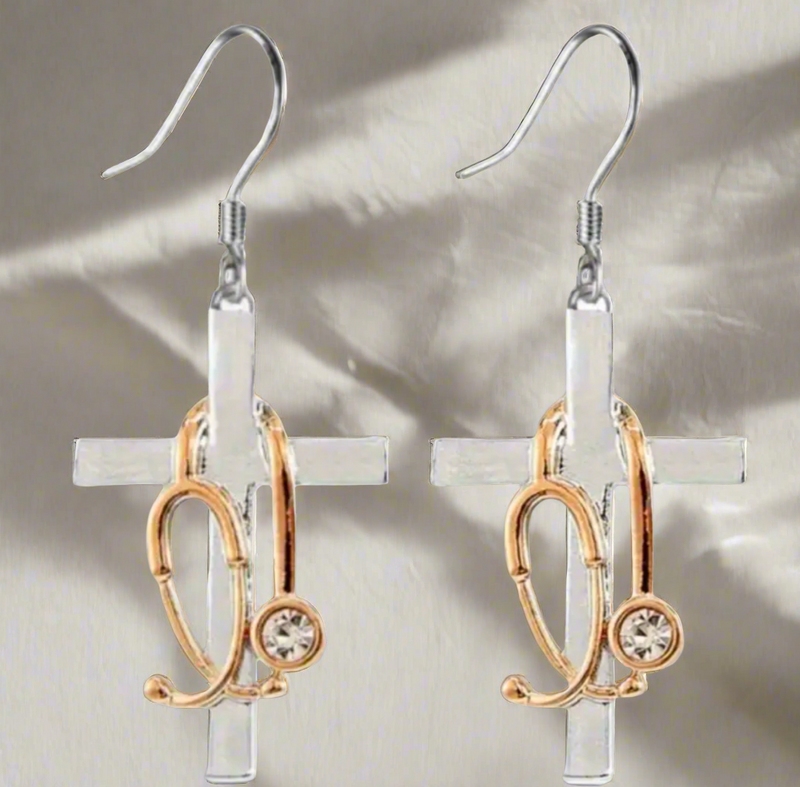 Silver cross earrings with gold-tone stethoscope charms and rhinestone accents, symbolizing faith and the medical profession.
