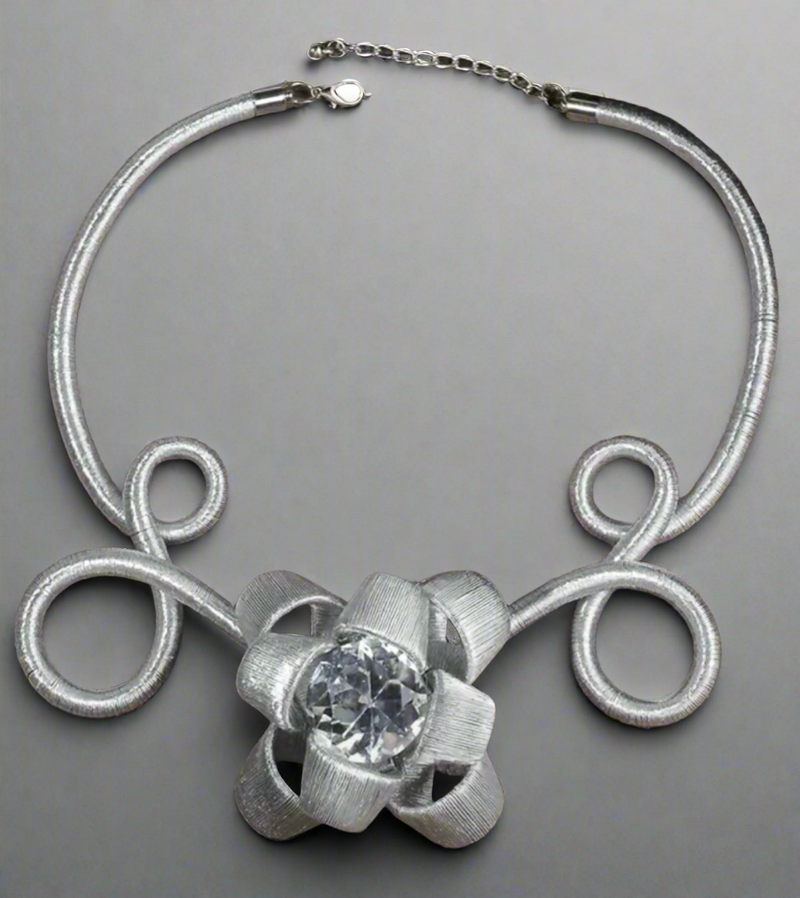 Elegant silver statement choker necklace featuring handcrafted wire loops and a dazzling crystal flower centerpiece, perfect for special occasions and bold fashion lovers