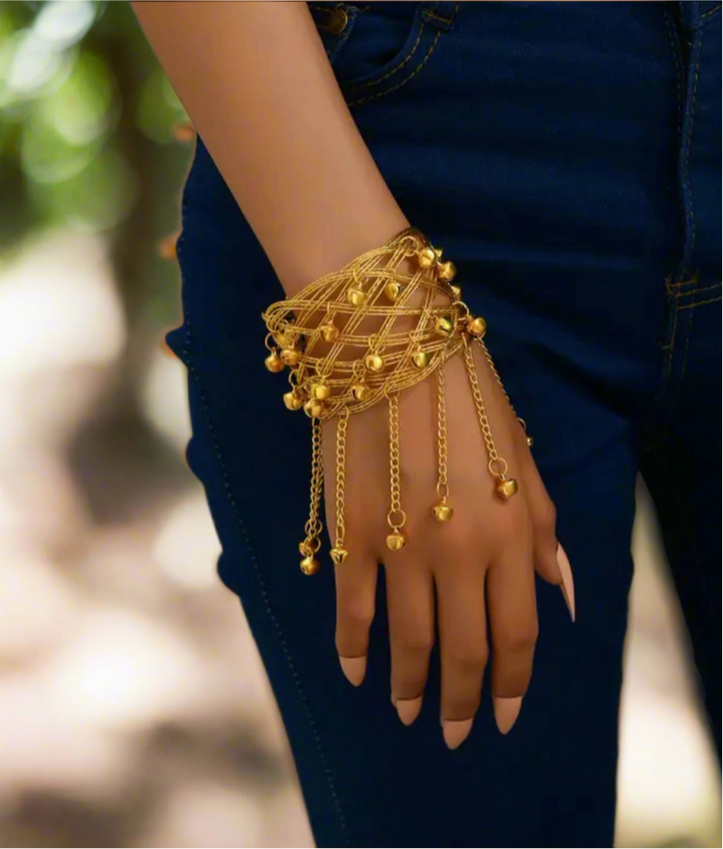 Gold-tone lattice cuff bracelet with dangling chain and bell charms, elegant statement jewelry for women, bold arm cuff with jingling accents.