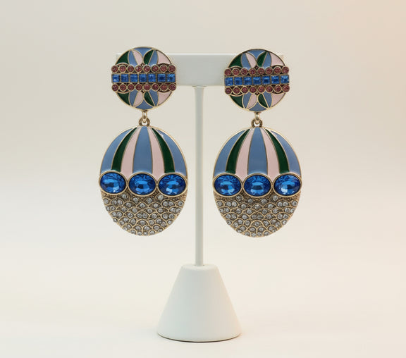 Jazz  Royal Lagoon earrings with blue oval crystals, gold filigree, and enamel detailing in green, pink, and lavender tones — luxury statement jewelry for women by Women Are Rubies.