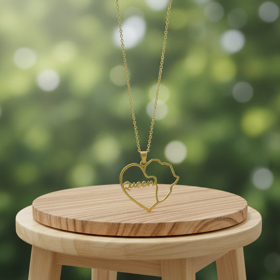 Gold necklace with a heart-shaped pendant on a wooden stand against a blurred green background