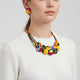 African-inspired Ankara print necklace with multicolor fabric-wrapped beads and matching button earrings displayed on a mannequin.