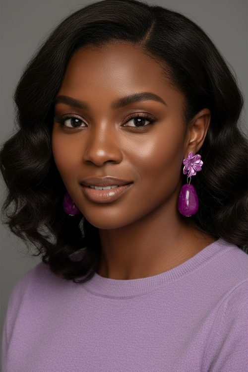Violet floral drop earrings with glossy magenta teardrop beads displayed on a jewelry card against a textured artistic background.