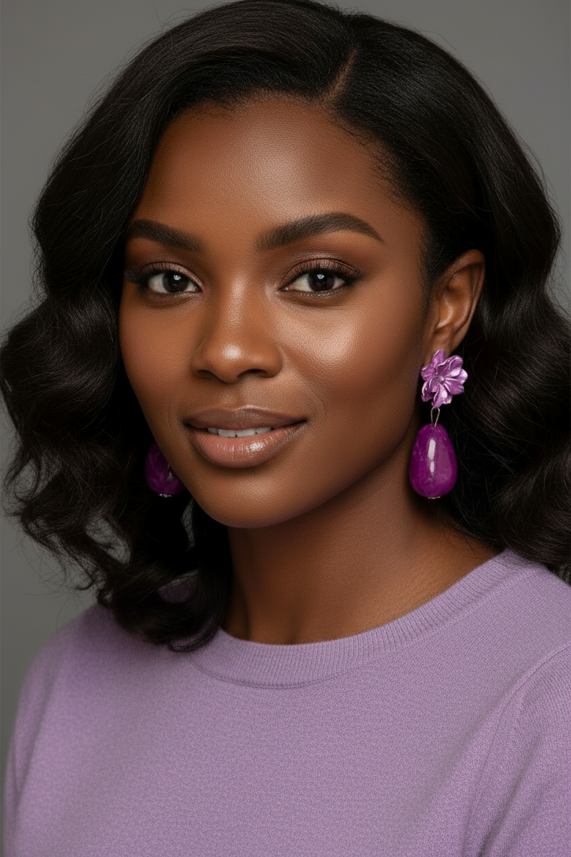 Violet floral drop earrings with glossy magenta teardrop beads displayed on a jewelry card against a textured artistic background.