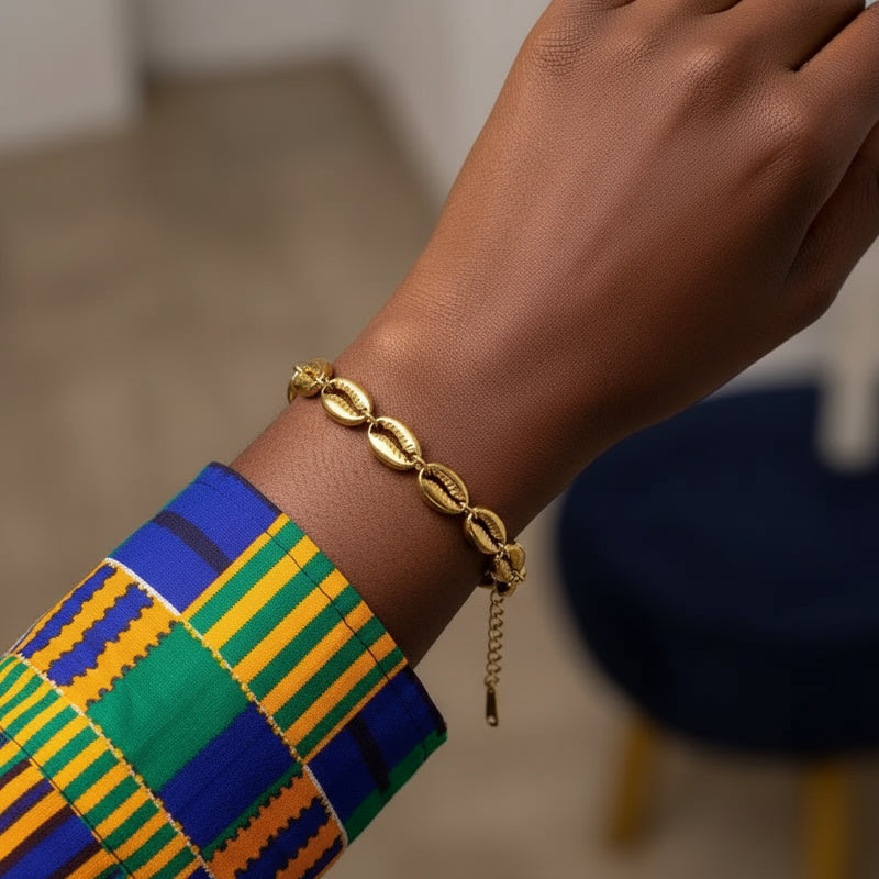 Gold bracelet with shell-like links on a brown surface